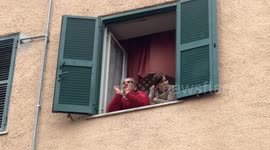 An elderly woman from the working-class neighborhood of Quarticciolo shouts the motto ‘Quarticciolo raise your voice’ from her window during during the demonstration to ask for the planning of structural interventions to redevelop the Quarticciolo in Rome