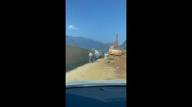 Truck in Vietnam flips and falls off the road