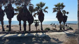 People on the beach of Lido di Ostia on a warm day in early March in Rome.