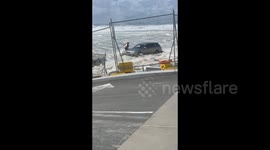 Aussie motorist rescues car being swept out to sea by strong waves whipped up by Cyclone Alfred