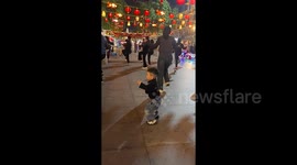 Three-year-old goes viral after effortlessly joining women's dance group and grooving out