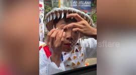 Street dancer tries and fails to wear contact lens using driver's window