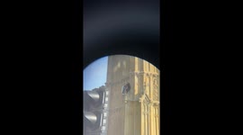 Man standing on Big Ben viewed through binoculars