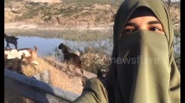 Woman talks to goats in Khairabad, they bleat in response