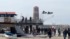 People in the area where the Bilancioni are built during the protest following the construction of a fence that limits access to the beach in front of the historic Bilancioni, once used for fishing, in Fiumicino near Rome.