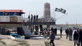 People in the area where the Bilancioni are built during the protest following the construction of a fence that limits access to the beach in front of the historic Bilancioni, once used for fishing, in Fiumicino near Rome.