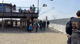 People in the area where the Bilancioni are built during the protest following the construction of a fence that limits access to the beach in front of the historic Bilancioni, once used for fishing, in Fiumicino near Rome.