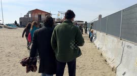 People in the area where the Bilancioni are built during the protest following the construction of a fence that limits access to the beach in front of the historic Bilancioni, once used for fishing, in Fiumicino near Rome.