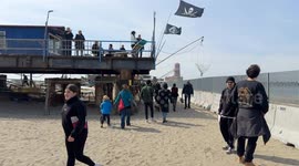 People in the area where the Bilancioni are built during the protest following the construction of a fence that limits access to the beach in front of the historic Bilancioni, once used for fishing, in Fiumicino near Rome.