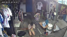 Two monitor lizards scurry through home while boy prays