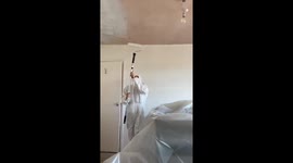 Painter gets covered in paint while working on ceiling