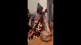 Multitasking master? Goblin elf slices bread, plays cello, and rocks the kazoo at the same time