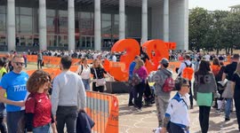Participants in the Rome Marathon around the large number 30 that was installed at the Expo Village where bibs and gadgets are collected at the Palazzo dei Congressi in Rome.