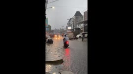 Motorcyclist catches fire while riding through flood in Indonesia