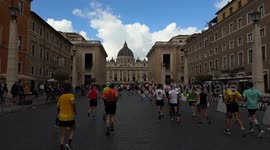 Runners arrive at St. Peter's Square with St. Peter's Basilica in the background during the Acea Run Rome The Marathon in Rome.