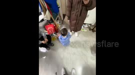 China:  A Baby's Adorable Hat-Removing Attempt 
