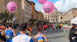 Runners arrive at St. Peter's Square with St. Peter's Basilica in the background during the Acea Run Rome The Marathon in Rome.