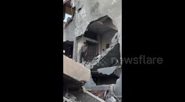 Locals inspect the destruction to their residential building in Gaza