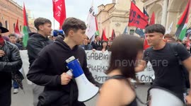 Young demonstrators marching behind a banner  shout slogans into megaphones during the demonstration to say no to rearmament called by left wing movements in Rome.