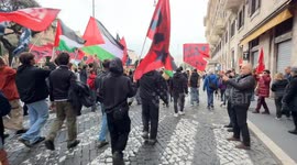 Young protesters march singing the song ‘whistle the wind’ and raising their arm with a closed fist during the demonstration to say no to rearmament called by left wing movements in Rome.
