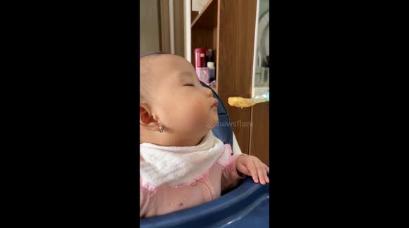 Baby boy still eats porridge despite being barely able to keep eyes open