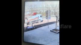 Tricycle mysteriously starts on its own after being sprayed by passing water truck