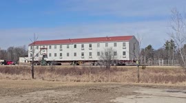 WWII barracks loaded onto truck to be moved in Fort McCoy, Wisconsin