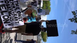 Democrats protesting Elon Musk outside of a Tesla Dealership