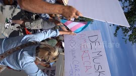 Democrats protesting Elon Musk outside of a Tesla Dealership