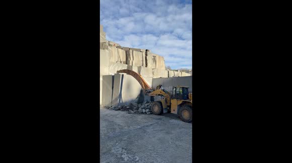 Pulling down a gigant granite slab from a quarry in Larvik, Norway. Real natural stone - Granite - Larvikite