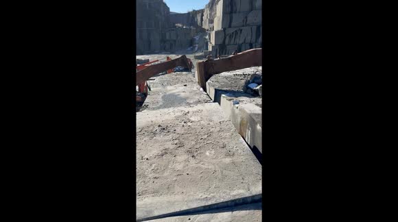 Pulling down a gigant granite slab from a quarry in Larvik, Norway. Real natural stone - Granite - Larvikite