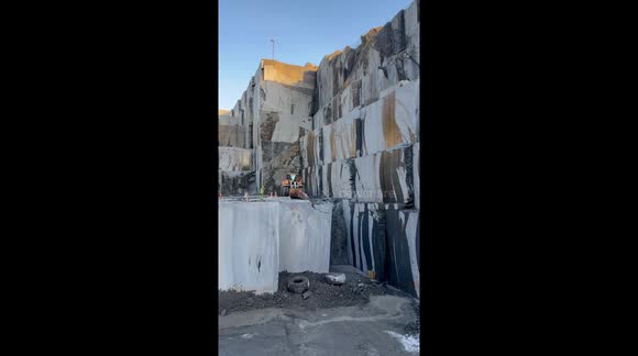 4K video of from a quarry in Larvik, Norway. Real natural stone, amazing and satisfying view of a gigant slab pulled over with a wheelloader from Volvo.