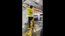 Builder works smarter not harder by walking with stepladder