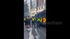 UK: A supporter is DE-ARRESTED after masses block the police van outside the Old Bailey