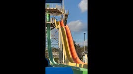 Petrified mum attempts to crawl back up water slide before reaching steep descent