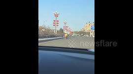 China: Delivery Rider Joyfully Riding a Scooter
