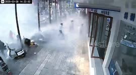 Rooftop tank collapsed by earthquake, cascading water then crashes onto pedestrians and vehicles below