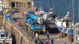 Tourism boats craned back into the harbour as 2025 Tourism season gears up for Easter. Newquay Harbour, Cornwall, UK