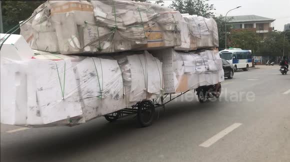 Wild motorbikes are ridiculously overloaded with countless foam boxes, It is like a giant truck! with a length of about 7 meters