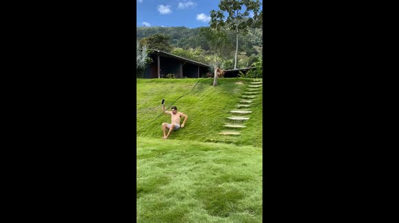Dog Celebrates Imitating Grassy Slide