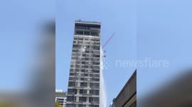 Crane plunges from apartment block in Bangkok during earthquake