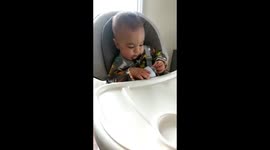 Baby surprised by orange juice magic trick.
