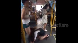 Woman pulls off man's shorts as she falls on bus