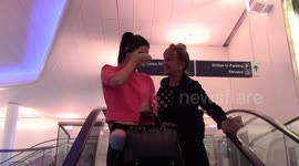 Kendall Jenner covers her face to avoid photographers as she arrives in LA