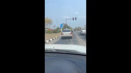 Passing bus load of Mitsubishi mechanics help driver with his broken down car