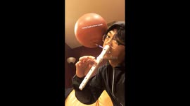 Man spins basketball, plays recorder with nose, and films all at once