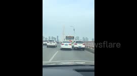 Two cars battle it out in one lane—refuse to yield, crawl forward side by side in petty road feud