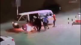 A public transport van burst into flames while refueling at a petrol station, forcing passengers to flee for their lives. The sudden blaze, captured on video, shows bright flames and thick smoke engulfing the vehicle as terrified passengers scramble to sa