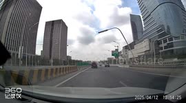 Streetlight blown over by strong winds smashes passing car in Beijing