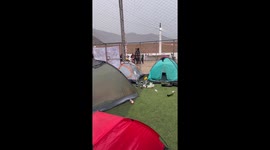Tent in Lima appears to move as people laugh and record outside